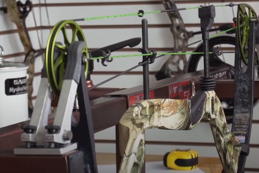 Compound bow on a bow press for string to be replaced